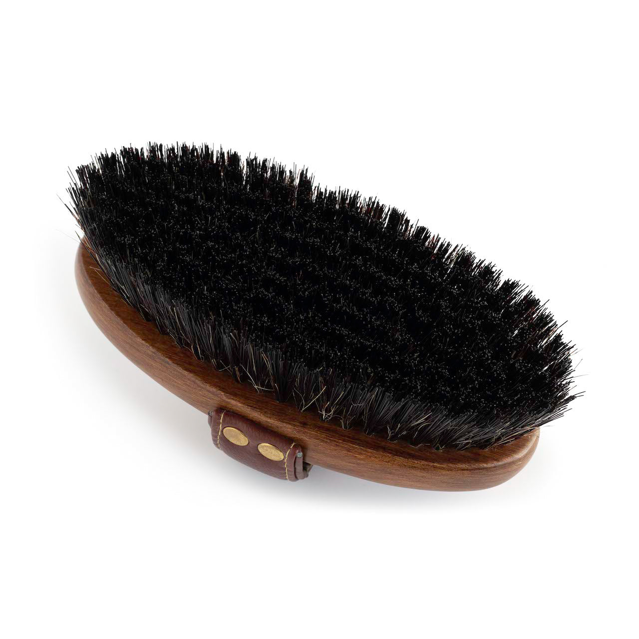 An image showing the underside of the Hairy Pony Dandy Brush. You can see the black bristles, beechwood material and gold detailing on the handle. 