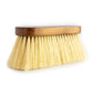 A side view of the Hairy Pony Flick Brush, with long bristles and wooden handle.
