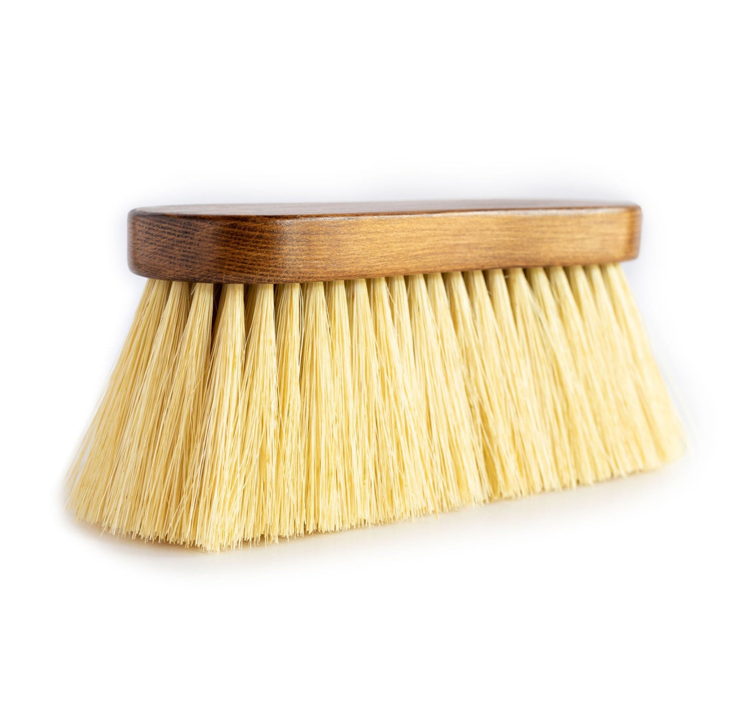 A side view of the Hairy Pony Flick Brush, with long bristles and wooden handle.