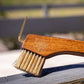 A close up view of the The Hairy Pony Copper Bristle Wooden Hoof Pick.