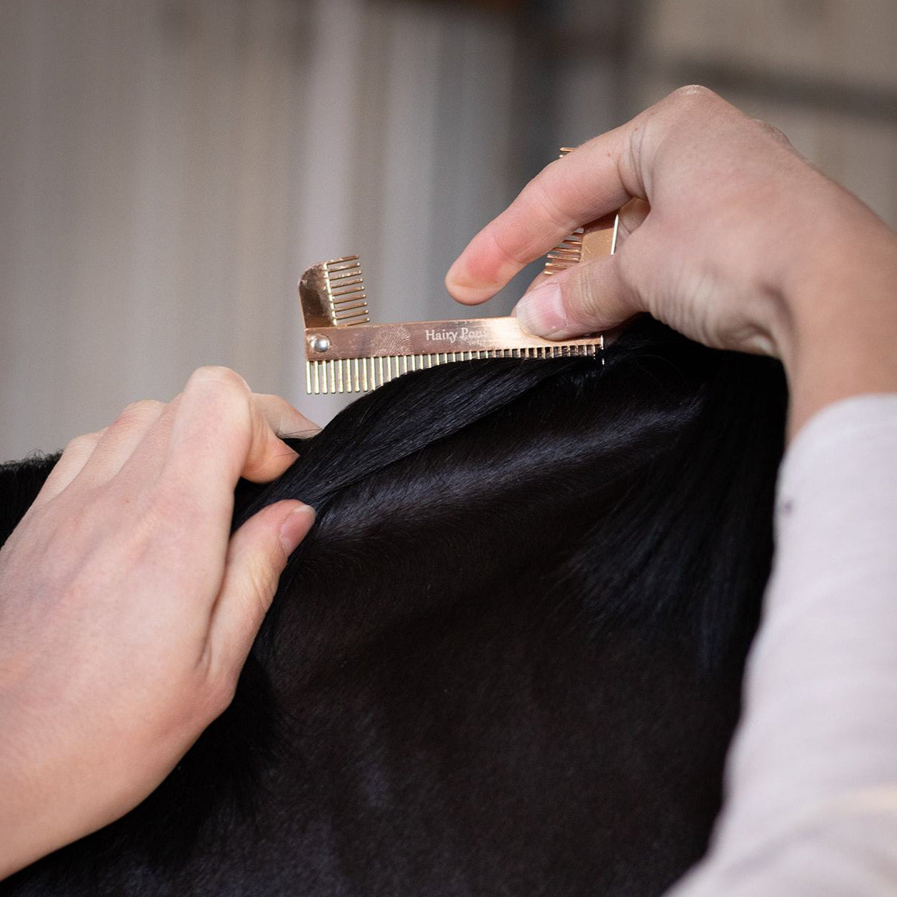 The Hairy Pony Horse Mane Sectioning Comb being used on a mane
