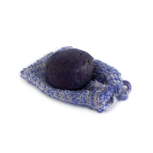 The Hairy Pony Purple Toner Shampoo Bar sitting on top of the biodegradable hessian bag in comes in for easy use and storage.