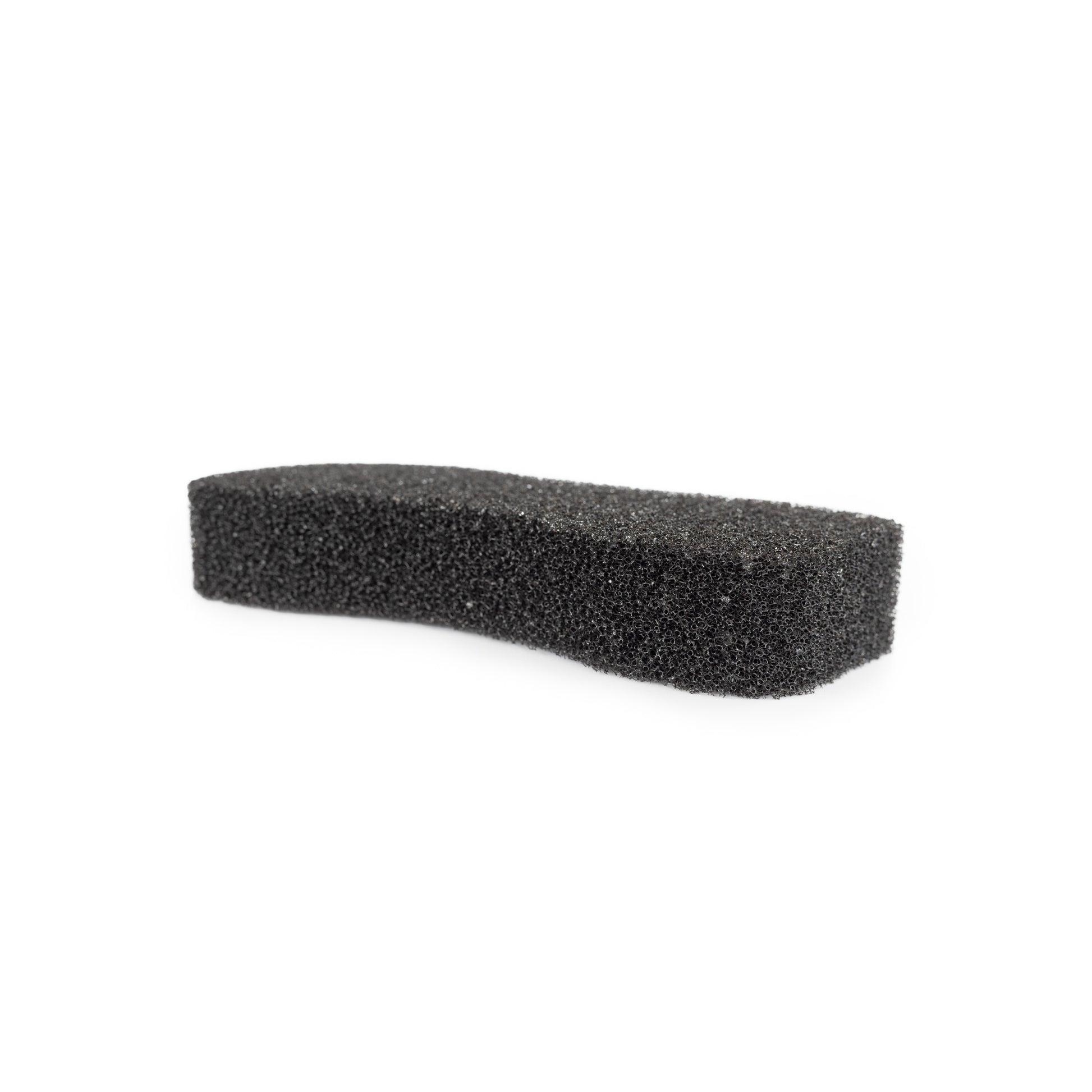 A photo of the Hairy Pony Compressed Scrubbing Horse Sponge after expanding with water. A black, coarse sponge on a white background.